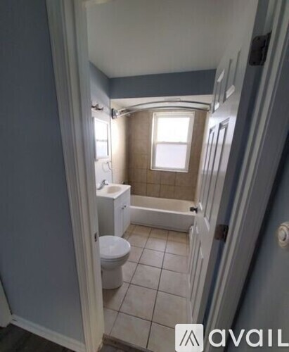 A bathroom with a toilet, sink, and bathtub.