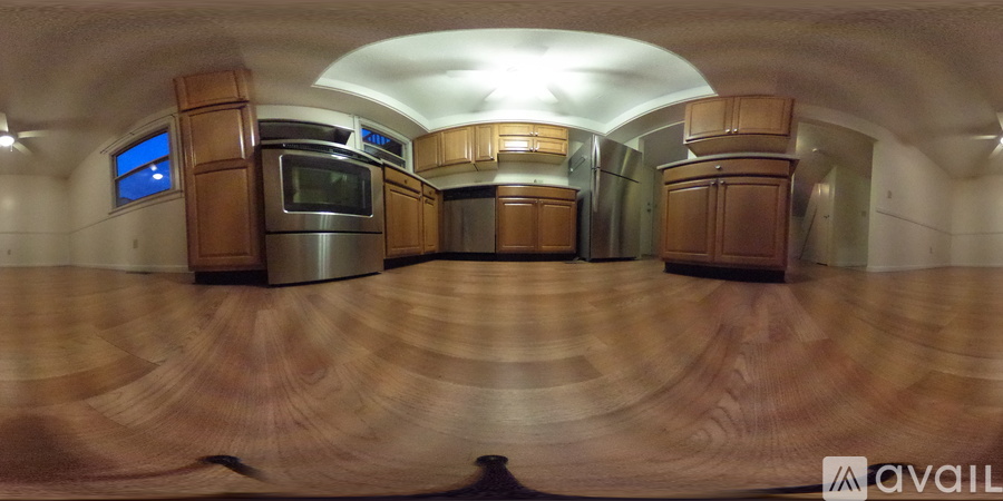 A kitchen with wooden cabinets and a stainless steel oven.