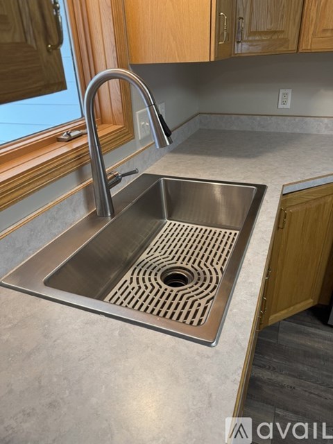 A kitchen sink with a drain in the middle.