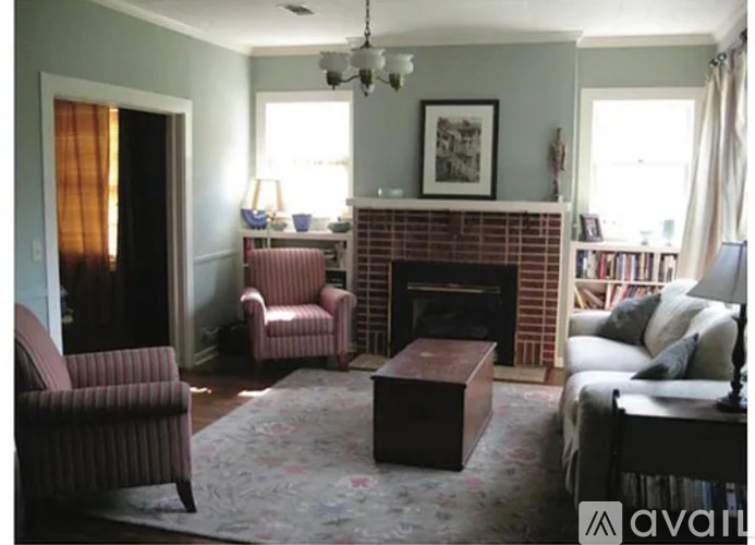 A living room with a fireplace and a chair.