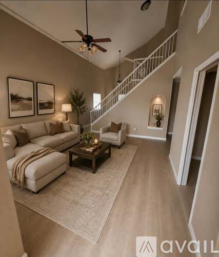 A room with a staircase and a ceiling fan.