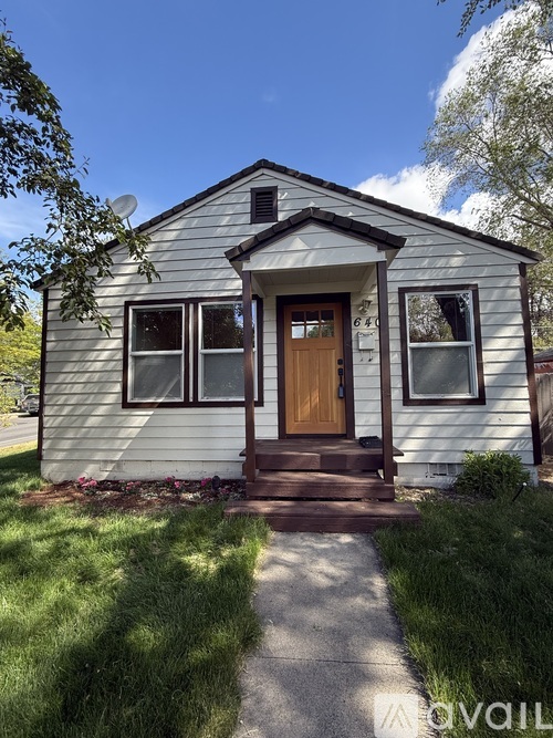 A small house with a brown door and windows.