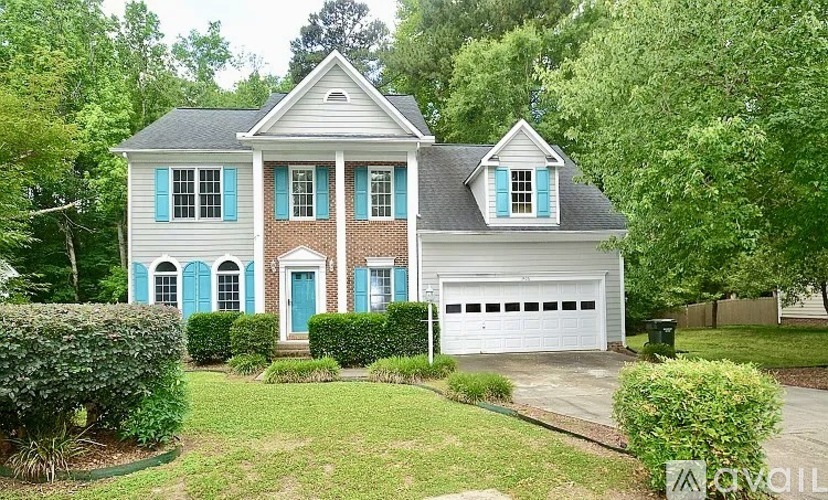 A house with a blue door and shutters.