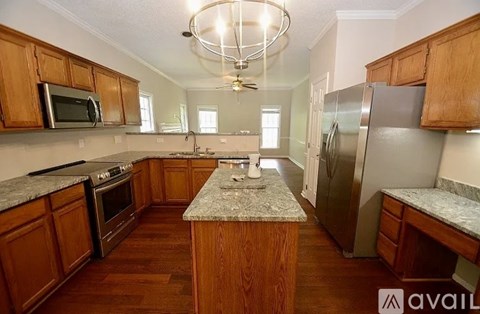 A kitchen with wooden cabinets and granite countertops.