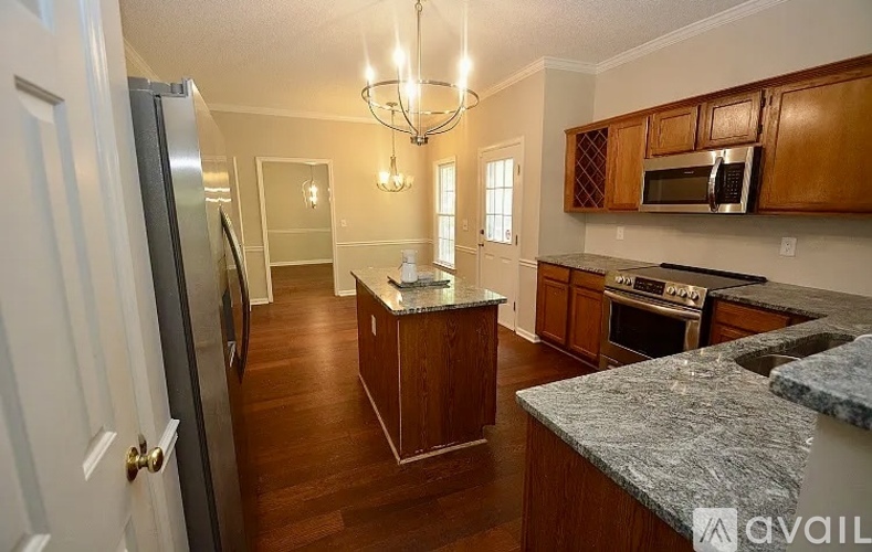 A kitchen with wooden cabinets and a granite countertop.