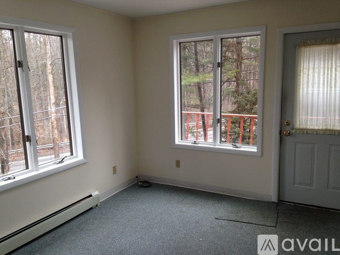 A room with a window and a door is available for rent.
