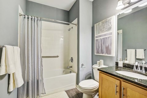 A bathroom with a toilet, sink, and shower.