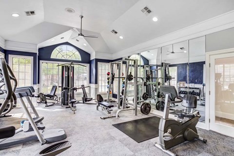 A spacious home gym with a variety of exercise equipment.