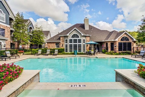 A large swimming pool in front of a house with a sign that says 3 FT 6 IN.