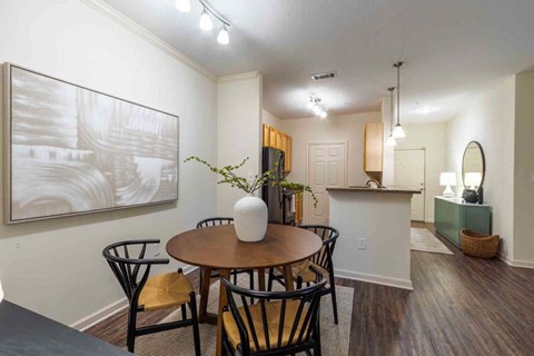 A dining room with a table and chairs.