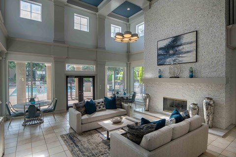 A living room with a fireplace and a painting on the wall.