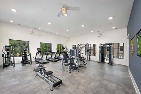 A spacious gym with a variety of equipment including treadmills, weights, and exercise machines.