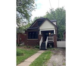 A house with a white front porch and a brick exterior.