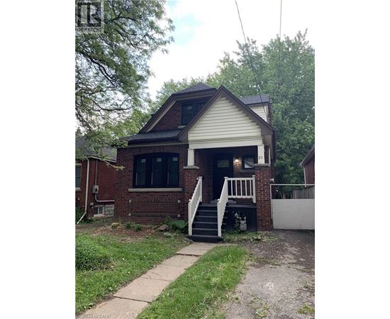 A house with a white front porch and a brick exterior.