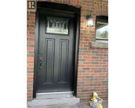 A black door with a glass window above it.