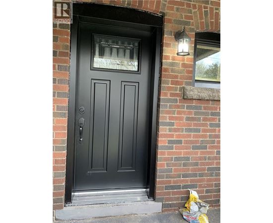 A black door with a glass window above it.