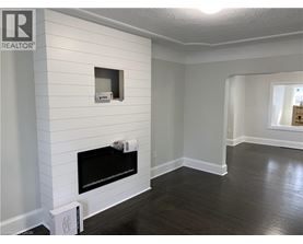 A living room with a fireplace and a window.
