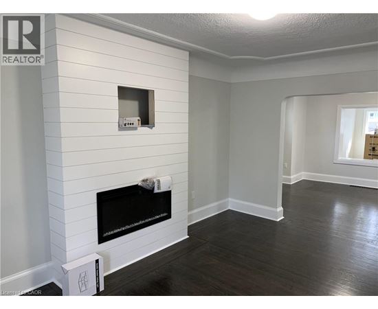 A living room with a fireplace and a window.