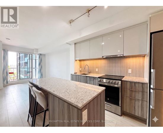 A kitchen with a granite countertop and stainless steel appliances.