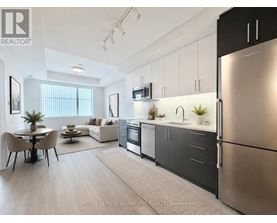 A kitchen with a sink, stove, and cabinets.
