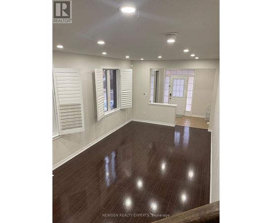 A room with wooden floors and white walls.