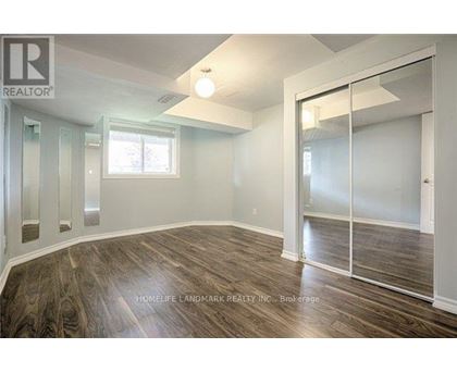 A room with wood flooring and a sliding glass door.