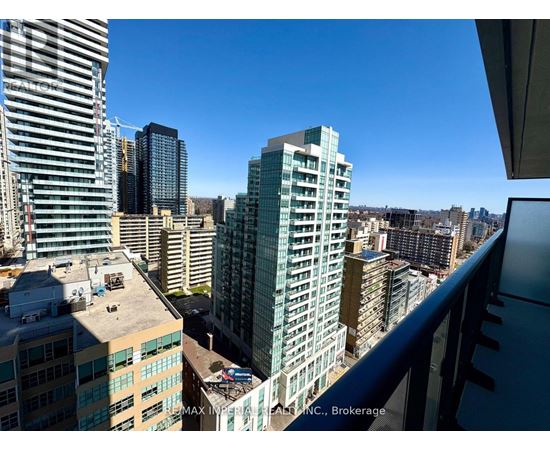 A cityscape with a clear blue sky and buildings of various heights.