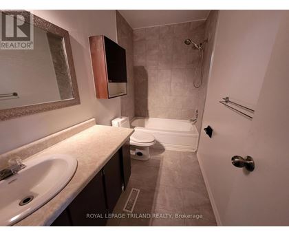 A bathroom with a sink, toilet, and shower.