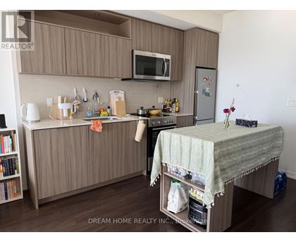 A kitchen with brown cabinets and a white countertop.