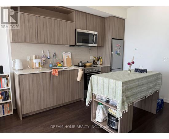 A kitchen with brown cabinets and a white countertop.