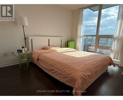 A bedroom with a large bed and a view of the city.