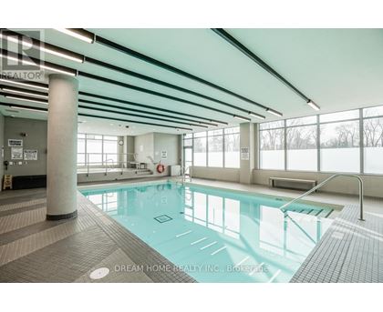A large indoor swimming pool with a glass bottom.