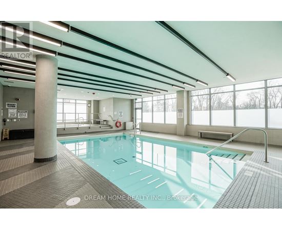 A large indoor swimming pool with a glass bottom.