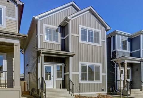 A modern house with a grey exterior and white trim.