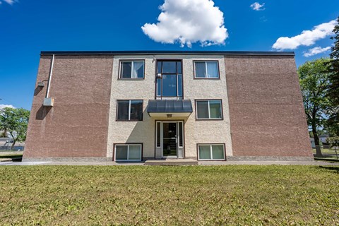 A brick building with a large front door and windows.