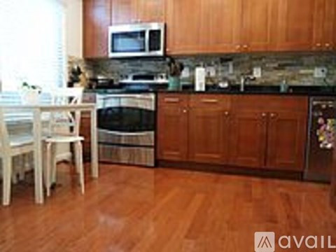 A kitchen with wooden cabinets and a black stove top.