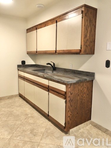 A kitchen with wooden cabinets and a granite countertop.