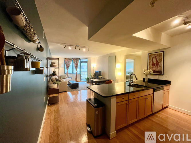 A kitchen with wooden floors and a large island in the middle.