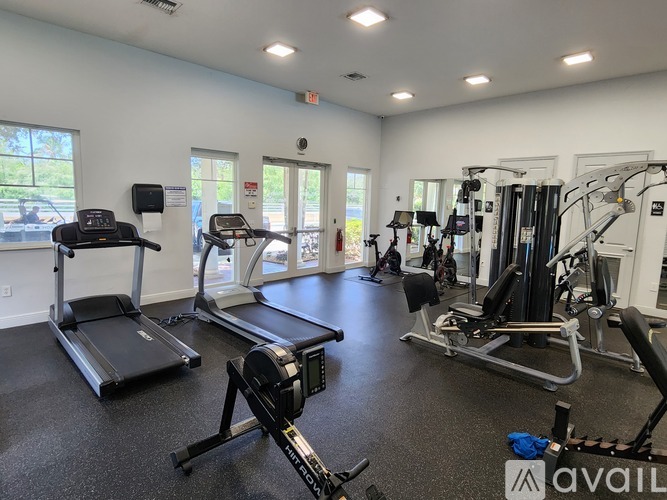 A gym with treadmills, elliptical machines, and other exercise equipment.