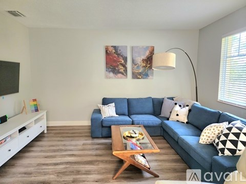 A living room with a blue couch and a coffee table.