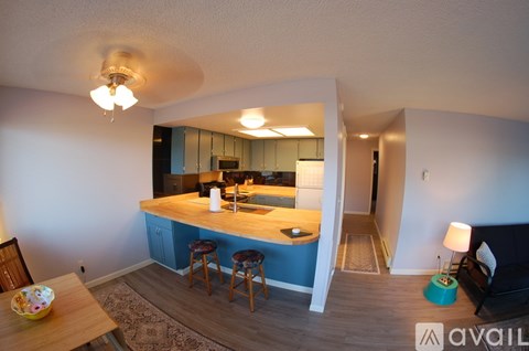 A kitchen with blue cabinets and a bar area.