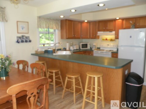 A kitchen with wooden cabinets and a white refrigerator.