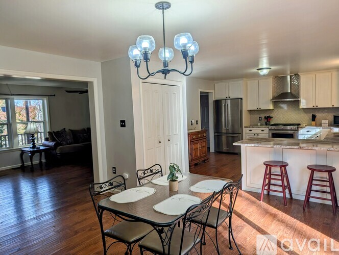 A dining room with a table set for four.