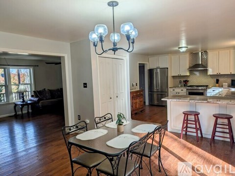 A dining room with a table set for four.