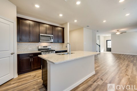 A kitchen with dark brown cabinets and a white island.