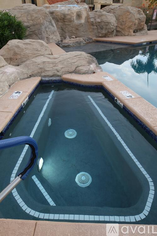 A hot tub with a blue handle and a black line on the side.