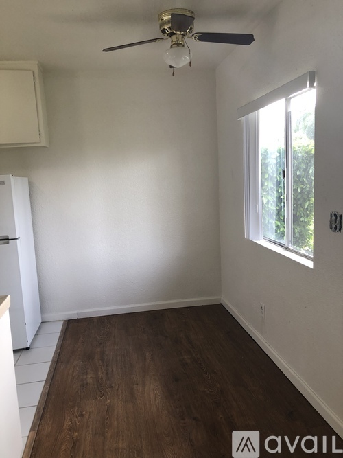 A room with a ceiling fan and a window.