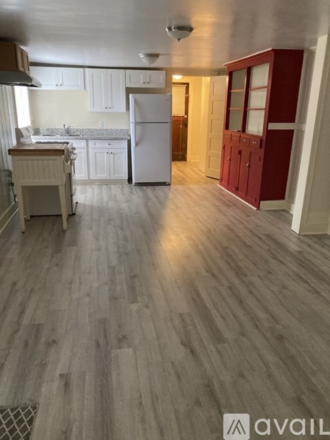 A kitchen with white cabinets and a wooden island.