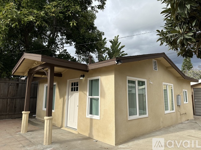 A house with a beige exterior and a brown roof is for sale.