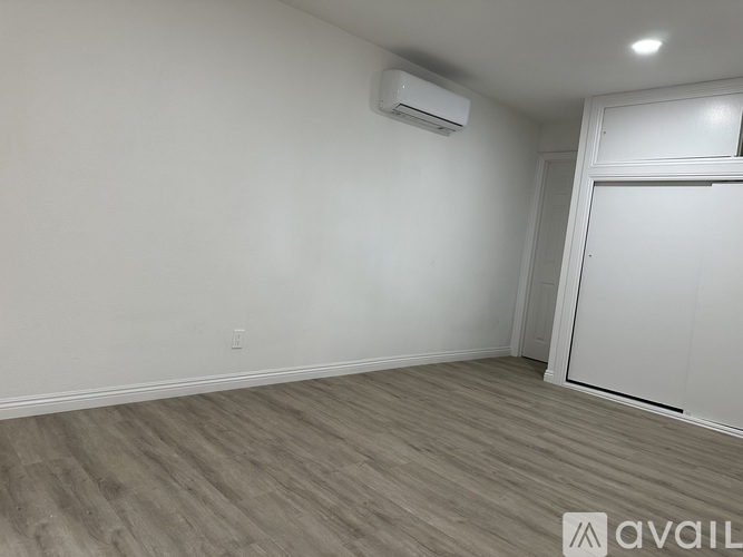 A room with a wall-mounted air conditioner unit.